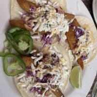 Fish Tacos · Three tacos with your choice of flour or corn tortillas filled with pan fried white fish, Me...