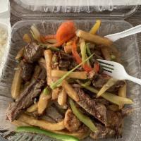 Lomo Saltado · Strips of grilled steak sautéed with tomatoes, onions, celery, green peppers, jalapeño peppe...