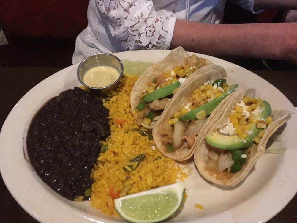 Shrimp Tacos · Shrimp sautéed with onions and green peppers, in white wine garnished with cilantro, avocado, queso fresco and three freshly made corn tortillas. Served with patron sauce on the side, Mexican rice, and refried beans.
