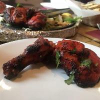 Tandoori Chicken · A royal treat chicken marinated in yogurt with mild spices and fine herbs and cooked in a ta...