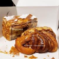 Almond Croissant · Croissant with sweet almond cream, sliced almonds, a nutty caramelized crust and dusted with...