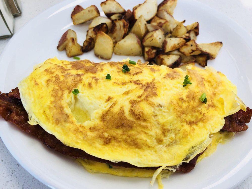 Omelette · Includes Ham, Peppers, Onions & Cheddar Cheese, Chive and potatoes on the side
