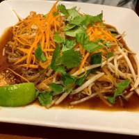 Pad Thai · Rice noodle stir fry with green onions, eggs and bean sprouts. Topped with carrots and cilan...