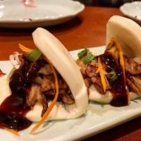 Bao Bao Buns · 4 pieces. Carmelized duck served in steam bao bun topped with carrots and scallions.