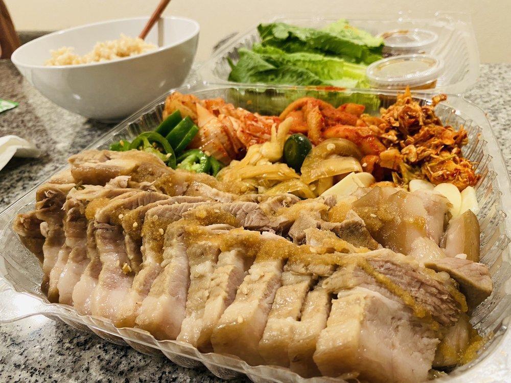 Daily Garlic Bossam · Boiled pork with vegetables with house garlic sauce. Serves 2