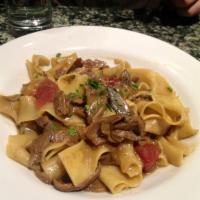 Pappardelle Della Nonna · Homemade ribbon pasta in a porcini mushroom sauce.