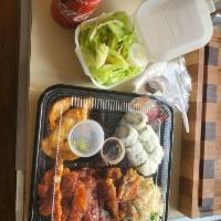 Chicken Katsu Bento · Japanese deep fried chicken cutlet. With California roll and 4 Pieces gyoza , rice and salad.