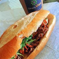 Simply Pork Banh Mi · Includes, cucumbers, cilantro, jalapenos, soy sauce, in-house mayonnaise, pickled carrots an...