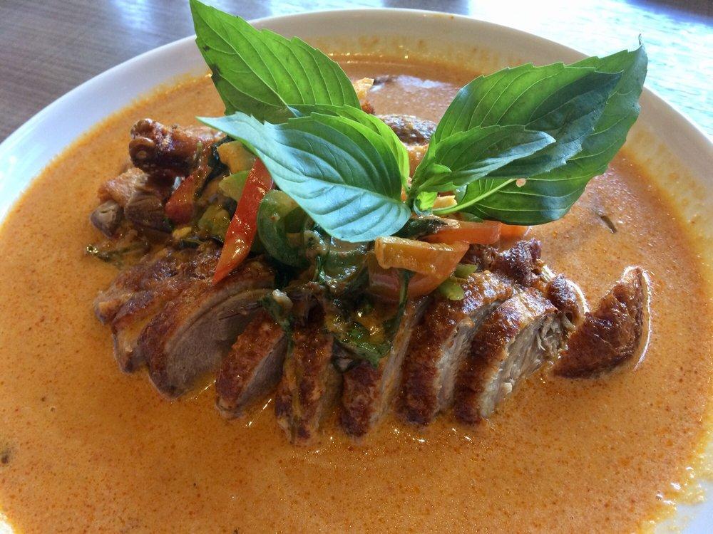 Panang Duck Curry · 1/2 duck in our savory panang curry with coconut milk, bell peppers, fresh lime, and basil.