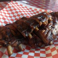 Famous Rib Shack Feast · 1 slab pork ribs, 1 slab beef ribs, 2 large sides of your choice, 6 cherrywood smoked links ...