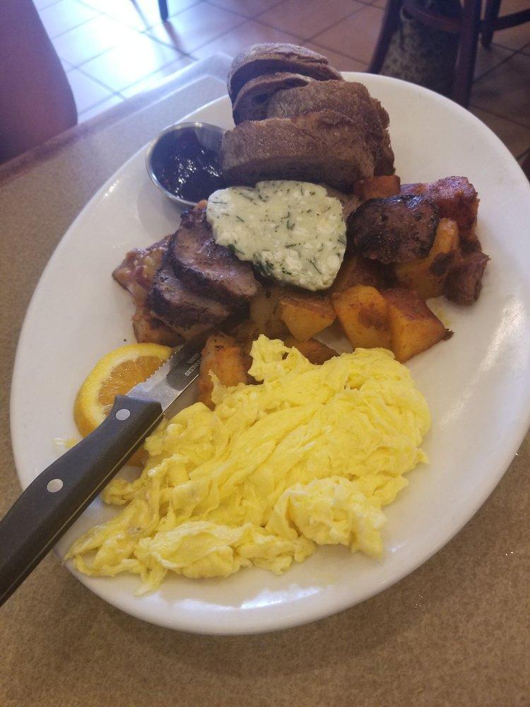 Steak and Eggs Breakfast · Grilled 8 oz rib eye steak, Three eggs scramble with spinach, roasted red peppers & gorgonzola,  Cadillac potatoes and toast.