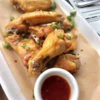 Salt & Pepper Wings · Fried chicken wings tossed with sea salt, cracked pepper, fried scallions,
jalapeños, and r...