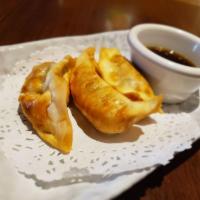 Gyoza · Steamed dumpling wrapped with cabbage and chicken, Served with black sweet soy sauce