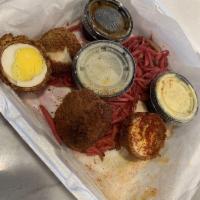 Scotch Eggs · 2 jumbo hard-boiled eggs wrapped in our chorizo breading, deep-fried, and then drizzled with...