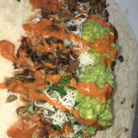 Pirate Burrito · Carne Asada, rice, refried beans, jack cheese, onions, cilantro, guacamole & salsa roja.