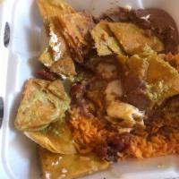 Chilaquiles · House chips fried with bacon, salsa verde & jack cheese. Served with refried beans,rice & a ...