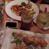 Manhattan Roll · Shrimp tempura inside with spicy tuna, crunch, scallions and tobiko outside.