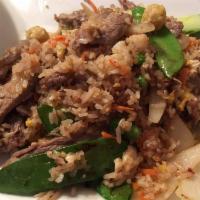 Siam Fried Rice · A traditional fried rice with egg onions, snow peas, carrots, tomatoes, baby corn, green pea...