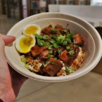 Adobo Bowl · Braised pork belly, adobo sauce, soft boiled egg, scallions and rice.