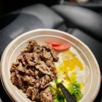 Tapsilog · Marinated thinly sliced Angus beef, garlic rice, fried egg, pickled red radishes and scallio...