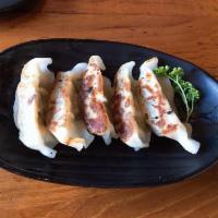 Gyoza · Pan-fried dumpling served with a soy-vinegar; dipping sauce.