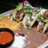 Street Tacos · 3 tacos served on soft corn tortillas filled with all pastor, with onion, cilantro, queso fr...