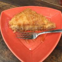 Baklava · Honey soaked flakey phyllo dough layered with chopped walnuts and almonds. Served warm with ...