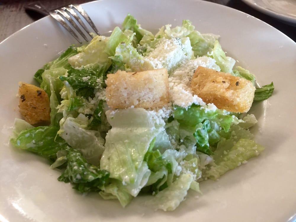 Caesar Salad · An Italian classic made with romaine lettuce, our creamy Caesar dressing and topped with shaved Romano and parmigiano cheeses.