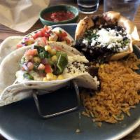 Carne Asada Tacos · 2 flour tortillas with grilled steak, caramelized onion, roasted poblano, corn relish, queso...