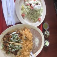 Sope · Fried thick corn base with your choice of meat, beans, cabbage, tomatoes, sour cream, and Co...