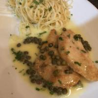 Chicken Piccata · Sauteed medallion of chicken topped with lemon butter sauce.  Served with angel hair pasta t...