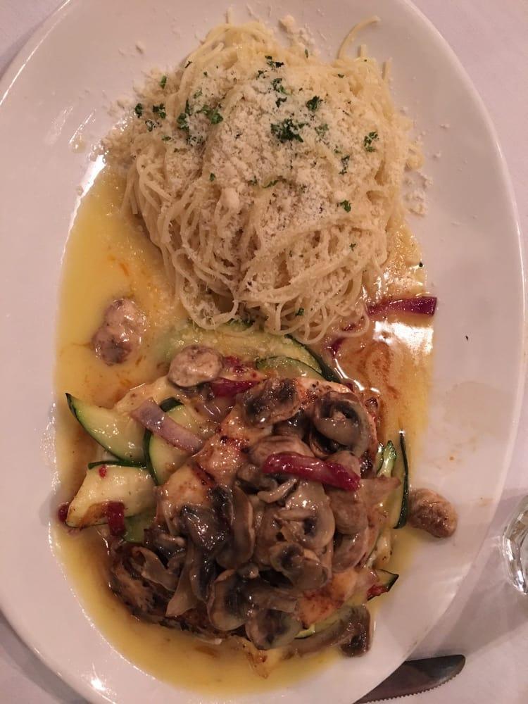 Chicken Napolitana · Grilled and stuffed with ricotta cheese, sun-dried tomatoes, mushrooms, red onions and zucchini in a lemon butter sauce.  Served with angel hair pasta topped with butter garlic sauce