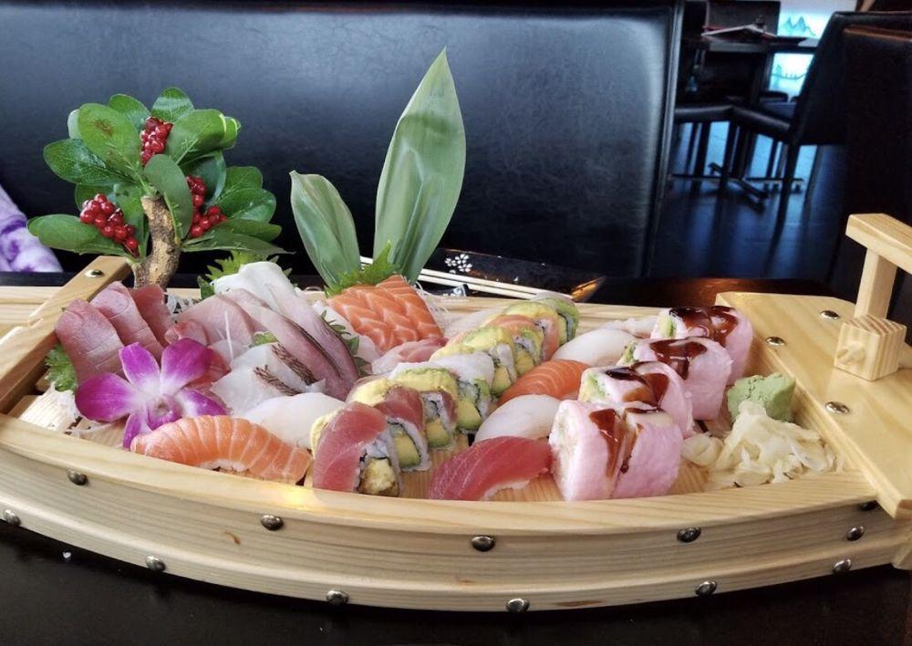Love Boat · 10 pieces sushi, 18 pieces sashimi with rainbow roll and pink lady roll.