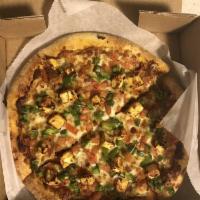 Butter Paneer Pizza · Butter sauce, paneer, diced tomatoes, diced bell peppers and fresh cilantro.