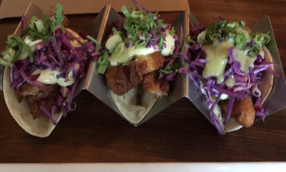 Fish Tacos · Beer battered cod, avocado mayo, corn bean sprout and red cabbage slaw, parsley, scallion and house-made hot sauce.