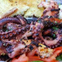 Octopus Salad · Spring mix salad with tomato, onion, balsamic dressing and side of rice and pita bread toppe...