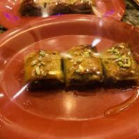 Baklava · 3 bite sizes of Pastry filled with chopped almonds and topped off with pistachios, and drizz...