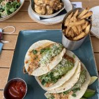 Slow Roasted Chicken Tacos · Salsa roja, guacamole, queso fresco, and lime.