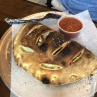 Chicken Broccoli Calzone · Roasted chicken, broccoli and grilled onions with Parmesan, ricotta and mozzarella cheese.