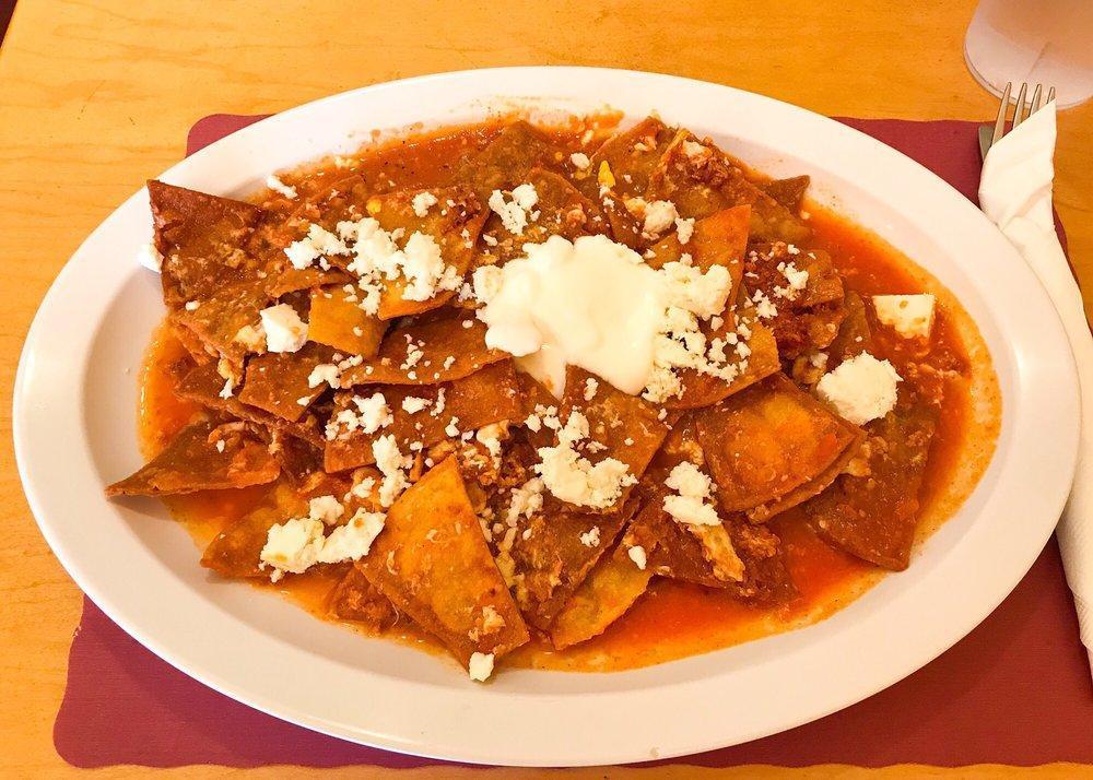 Chilaquiles · A scramble of tortilla chips, eggs and chorizo topped with sour cream and fresh cheese.