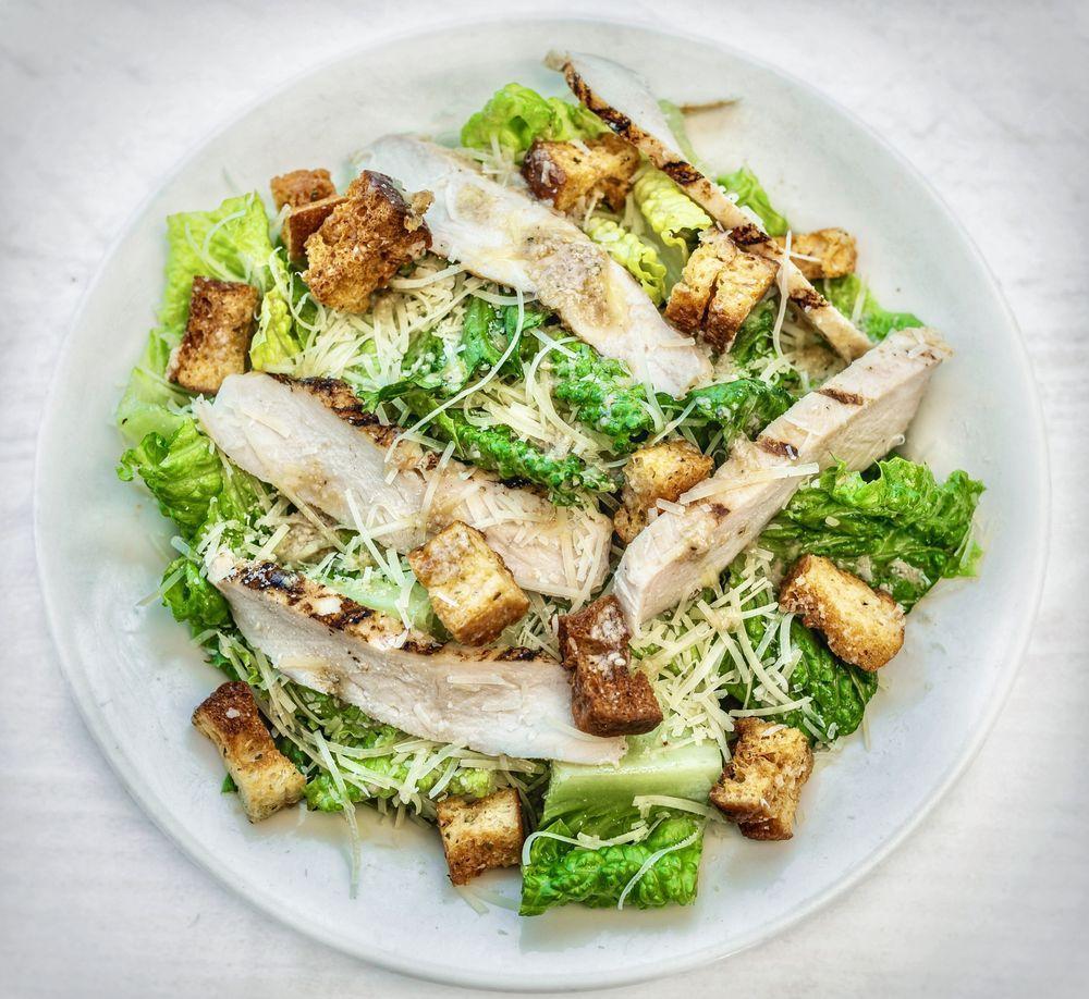 Caesar Salad · Crisp romaine, housemade croutons, freshly grated Parmesan. Served with Caesar dressing. Complimentary anchovy fillets added upon request.