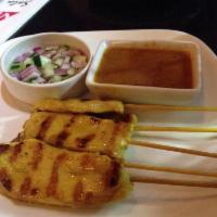 Chicken Satay · Grilled marinated chicken on sticks with peanut dipping sauce and cucumber relish.