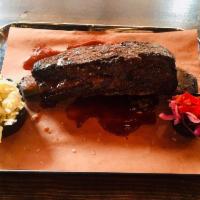 Brontosaurus Rib · On-the-bone, slow-smoked short rib with almost a full pound of meat on the rib. Served with ...