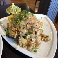 Pineapple Fried Rice · Pan fried rice with shrimp, chicken, eggs, pineapple, cashew nut, onions and raisins with cu...