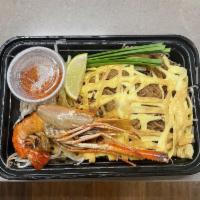 Pad Thai Boran · Stir-fried thin rice noodles encased in an egg omelet with jumbo prawn, shrimp, peanuts, dri...