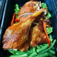 Chu Chee Duck · Crispy long island duck with chu chee sauce on a bed of steamed string bean, snow peas serve...