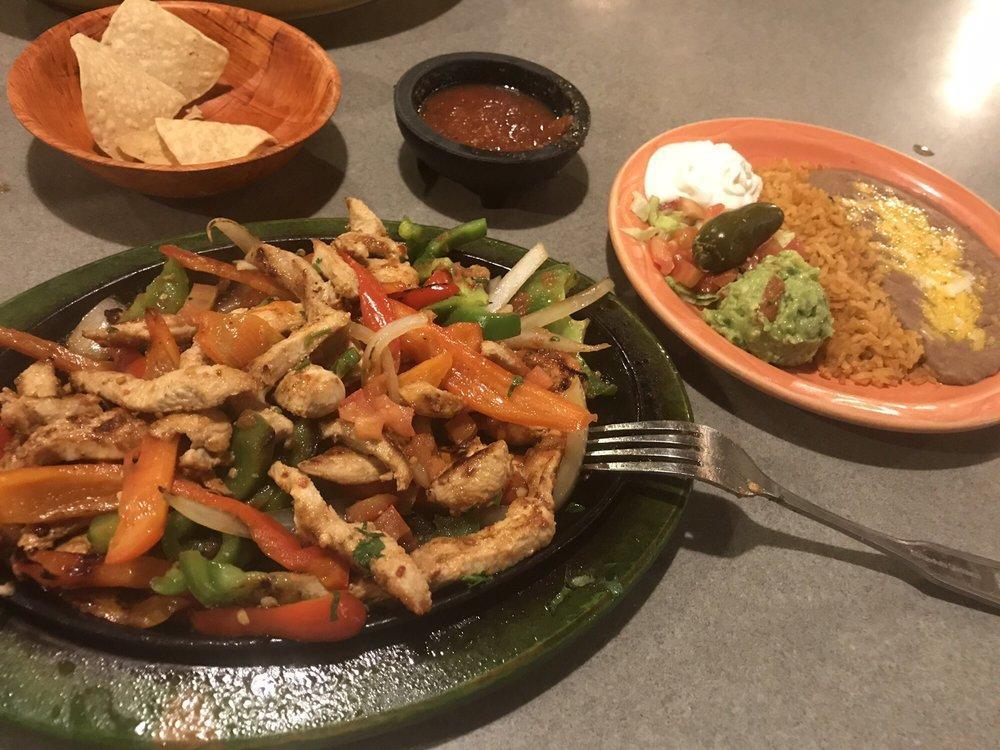 Chicken Fajitas · Tender pieces of marinated chicken sauteed with bell peppers, onions and tomatoes. Garnished with sour cream and guacamole.