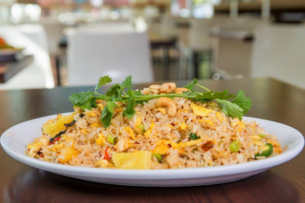 Spicy Thai Fried Rice · Fried rice cooked with a blend of special Thai herbs, eggs, diced onions and peppers, jalapenos, pineapple, Thai basil, cilantro and cashews.