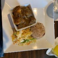 Curry Goat · Tender goat meat seasoned with our authentic Jamaican curry and simmered in a smooth sauce. ...