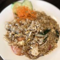 Thai Fried Rice · Stir fried rice with egg, tomato, garlic, onion and scallion.